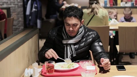 Young guy having lunch in a cafe Stock Footage 82357359