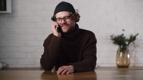 Young guy having a phone call with best friend. Guess what happened, you will Stock Footage 263709390