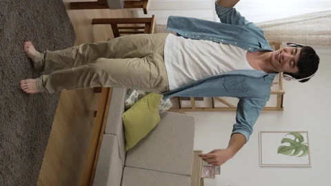 Young guy with a headset is dancing to the rhythm Video stock 209537683