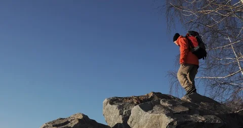 Young guy is hiking on the difficult route with big stones in mountains and Video stock 106085912