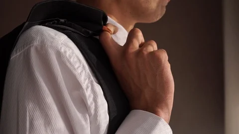 Young guy holding a jacket in his hands and looking out the window, businessman Stock Footage 127432968