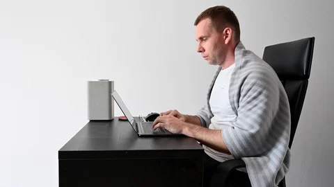 A young guy at home working at a computer in quarantine Stock Footage 127409410