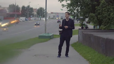 A young guy in a jacket holds a glass and dances Video stock 155986235