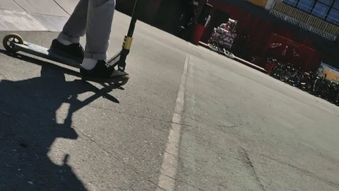 A young guy jumps and does tricks on a scooter in a skatepark Video stock 94142660