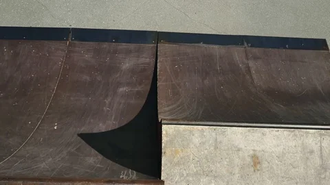 A young guy jumps and does tricks on a scooter in a skatepark Video stock 94142882