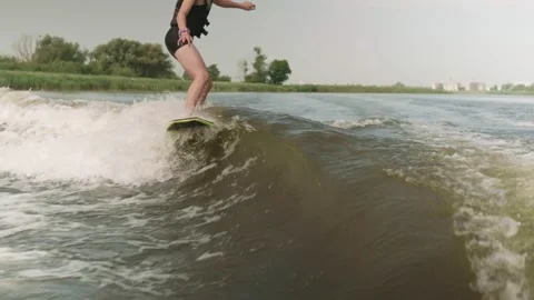 Young guy learning to ride wake surfing Stock Footage 158793234