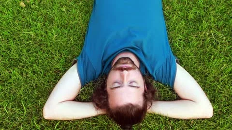 Young guy lie down on grass Video stock 10587580