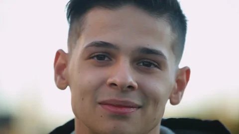 Young guy look at camera outdoors Vidéo 97409179