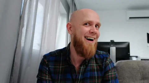 Young guy looking at the camera playfully winks and sticks out his tongue. Video stock 139193561