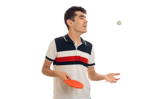 Young guy looking to the side and holding a tennis racket Stock Photos