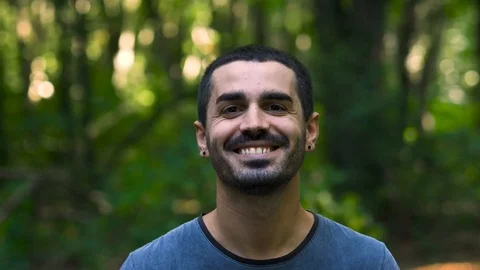 Young guy looking at the trees and smiling Stock Footage 117066887