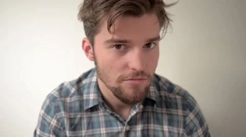 Young guy looks at camera and smiles Stock Footage 55152742