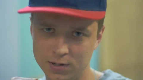 Young guy looks at the camera and waves his fists Stock Footage 81781545