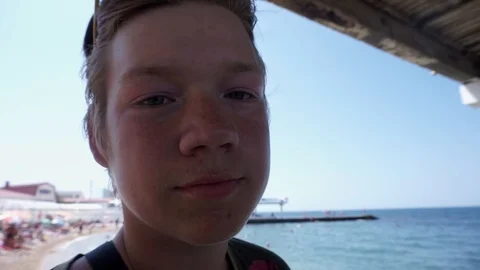 Young guy looks into the camera and says something Stock-Footage 102780002