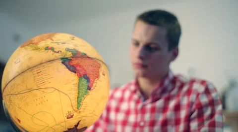 Young guy looks Globe Stock Footage 48593506