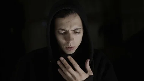 The young guy looks at his hands in surprise with fear Stock Footage 120597613