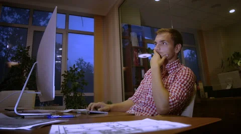 The young guy looks for information in the Internet Stock Footage 58014879