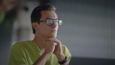Young guy looks thoughtfully to side and rubs his palms while sitting in cafe Stock Footage 343513768