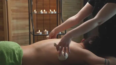 Young guy lying on desk table enoying spa treatment, massage on back. Stock Footage 152450714