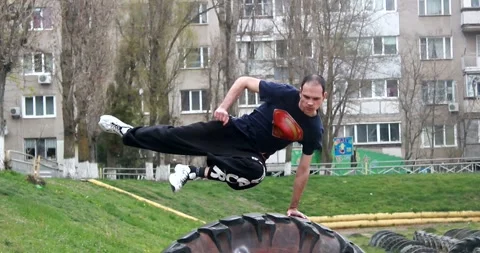 A young guy makes a speed vault in parkour style through a large ramp Stock Footage 265051267