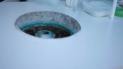 Young guy making cotton candy on a special machine, it wears bow tie, behind him Video stock 64040863