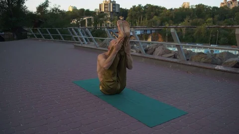 Young Guy with Naked Torso Demonstrates Good Flexibility by Performing Yoga Stock Footage 85334037