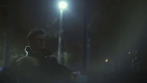 Young guy at night on the street Stock Footage 77377324