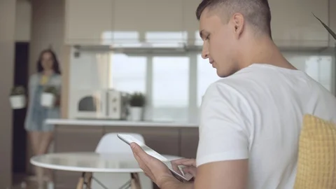 Young guy orders pizza using online store and a tablet Stock Footage 113752367