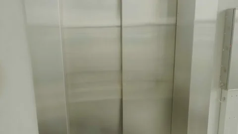 A young guy in an overhead beard dances in an elevator Stock Footage 134021562