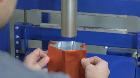 A young guy is packing coffee beans in a package. Stock Footage 82307811