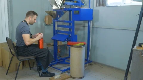 A young guy is packing coffee beans in a package. Stock Footage 82307991