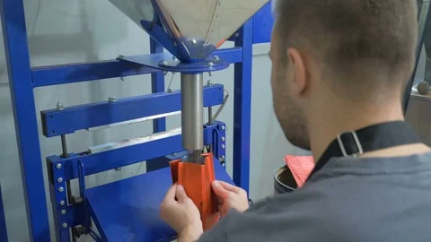 A young guy is packing coffee beans in a package. Stock Footage 82308295