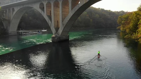A young  guy is paddling on SUP  board in rivers junction between Rhone and Arve Video stock 97701286