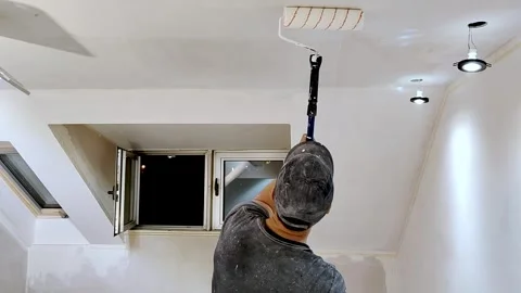 Young guy painting the ceiling and tools and buckets Stock Footage 240625169
