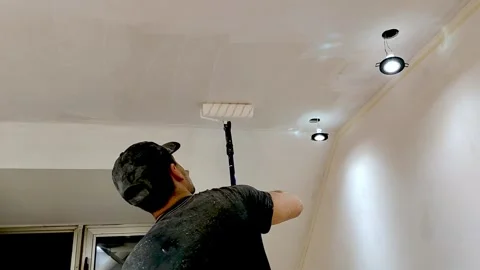 Young guy painting the ceiling Stock Footage 240625155