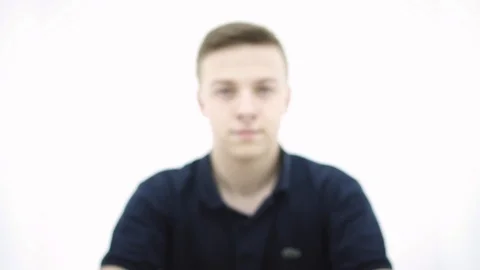 Young guy picks up a symbol plastic cup and crush the plastic cup Stock Footage 107433228