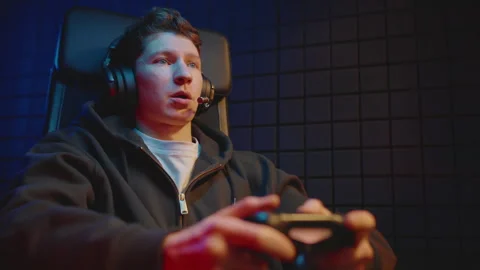 Young guy play online video game on computer use joystick. Gaming console. Video stock 328236200