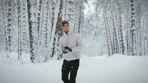 Young guy play snowballs in the winter forest. Stock Footage 169817494