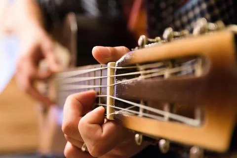 Young guy playing the classical guitar Stockfoto's