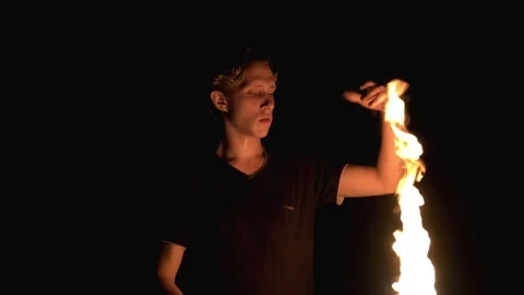 Young guy playing with fire. Dangerous stunt. Fire show Stock Footage 140199170
