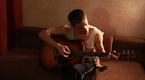 Young guy playing guitar, Full HD 1080 Video stock 33798157