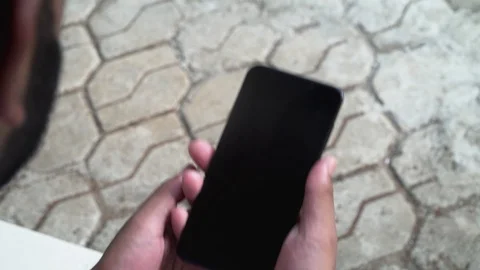 Young guy playing on his phone green screen games enjoying smartphone Stock Footage 127808435