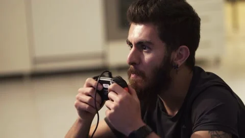 Young guy playing a video game on TV Stock Footage 131403623