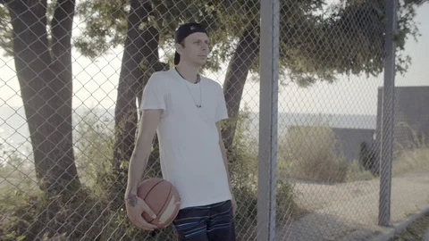 A young guy plays with a ball at dawn. Stock Footage 121094171