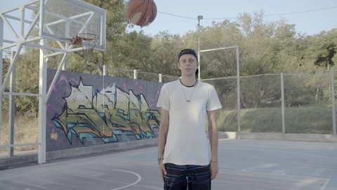 A young guy plays with a ball at dawn. Stock Footage 121094582