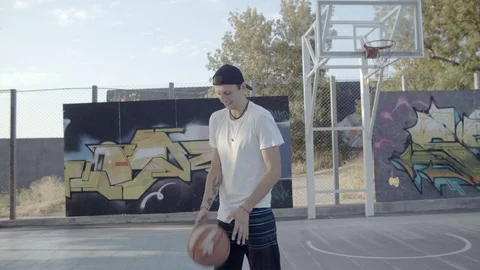 A young guy plays with a ball at dawn. Stock Footage 121095191