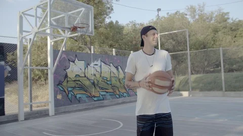 A young guy plays with a ball at dawn. Stock Footage 121095238