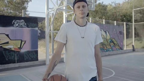 A young guy plays with a ball at dawn. Stock Footage 121095693