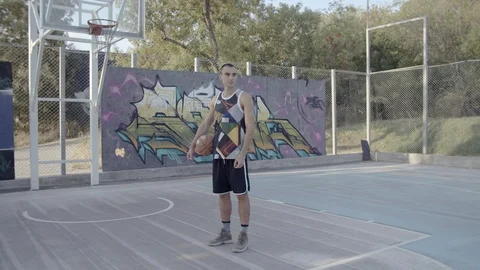 A young guy plays with a ball at dawn. Stock Footage 121144387