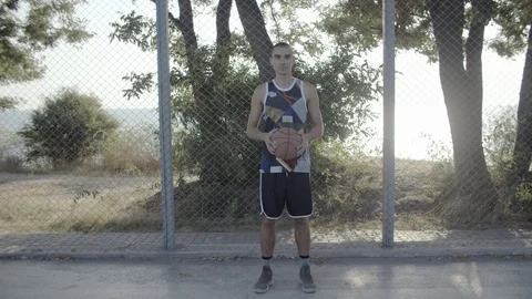 A young guy plays with a ball at dawn. Stock Footage 121144841